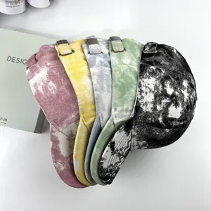 Macro detail of multi-color tie-dye baseball caps with adjustable silver metal buckles