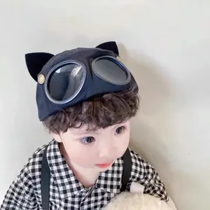 Close-up of black cotton baseball cap featuring cat ears and aviator goggles decoration