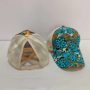 Detail of high ponytail baseball cap featuring elastic cross bands and sunflower leopard print