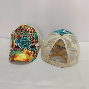 Detail of cross elastic ponytail band and leopard print on mesh trucker cap