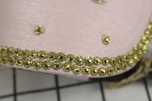 Macro shot of pink fabric baseball cap with sparkling rhinestones and studded details