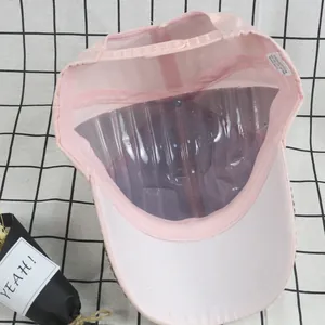 Internal view of pink mesh trucker hat with 100% cotton label and adjustable snapback