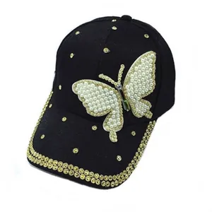 Fashionable black baseball cap featuring a large pearl butterfly design and gold rhinestones