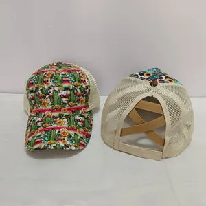 Detail of bohemian ponytail trucker hat featuring cross elastic bands and floral mesh design