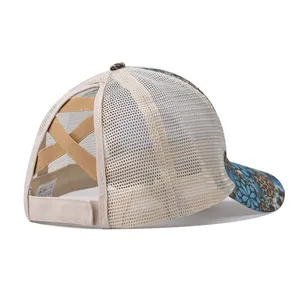 Detail of beige mesh ponytail baseball hat with floral brim and elastic crisscross back