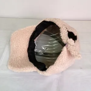 Detail view of the warm lamb wool lining and internal structure of this beige winter cap