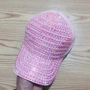 Detailed view of pink baseball cap featuring luxurious rhinestone and pearl embellishments