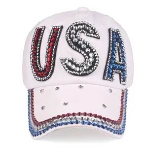 Close-up of sparkling USA rhinestone lettering on white cotton baseball cap with rhinestones