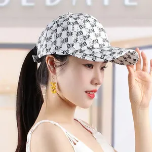Detail of white baseball cap with BF monogram print, rhinestones and ponytail opening