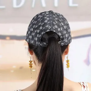 Detail view of denim baseball cap with rhinestone BF pattern and ponytail opening