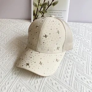 Detailed view of beige mesh baseball cap with silver rhinestones and star charms