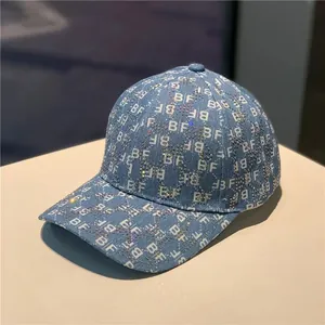 Blue denim baseball cap with rhinestone BF monogram pattern and curved brim in street style