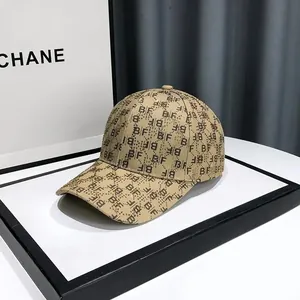 Detailed close-up of khaki baseball cap with BF monogram and shimmering rhinestones