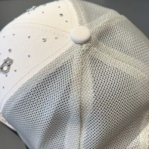 Detailed macro view of the rhinestone-embellished letter B on the breathable mesh cap