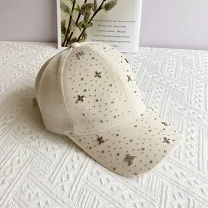 Detail of cream mesh baseball cap with rhinestone four-leaf clover and breathable mesh panels