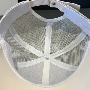 Close-up of mesh lining and adjustable metal buckle on rhinestone baseball cap