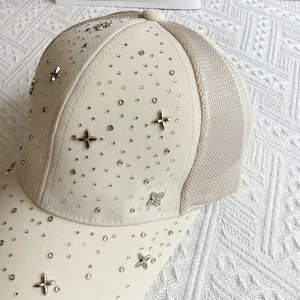 Detail of light beige baseball cap with breathable mesh and sparkling rhinestone clover accents