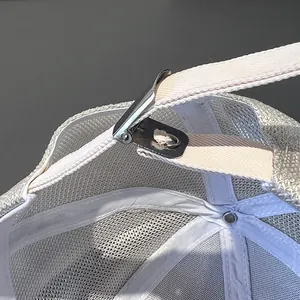 Detail of adjustable metal buckle and breathable white mesh on the baseball cap back