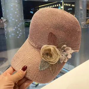 Detailed view of pink knitted mesh cap with 3D sequin flowers and bead accents