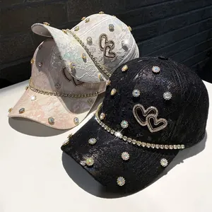 Close-up of sparkling rhinestones and lace pattern on a stylish baseball cap detail