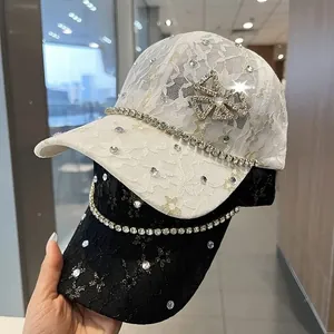 Detailed view of luxury lace baseball cap with sparkling rhinestones and metal bow charm