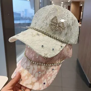 Detail of lace baseball caps featuring rhinestone clover and sparkling bow jewelry accent