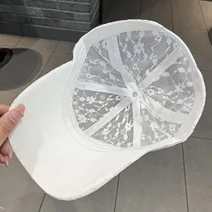 Detail of white lace baseball cap showing breathable inner mesh and support structure