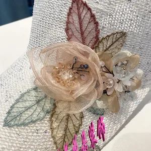 Detail of handmade mesh flowers with sequins and beads on a breathable knitted cap