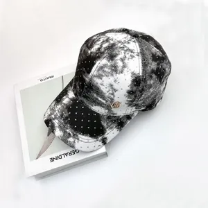 Macro shot of marble texture baseball cap with silver rhinestones and metal H logo