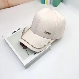 Elegant beige satin baseball cap with jacquard floral pattern and rhinestone rim detail