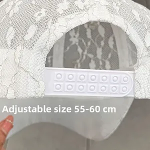 Detail of adjustable snapback closure on white lace baseball cap, size 55-60cm
