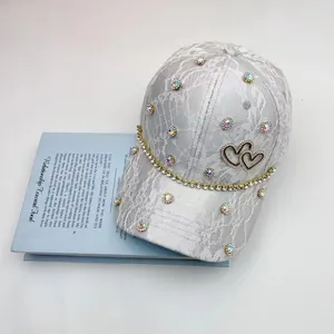 Light gray lace baseball cap with sparkling rhinestones and metal double heart logo detail