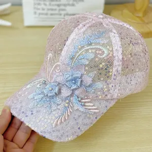 Close-up of pink mesh cap featuring intricate 3D floral embroidery and pearl accents