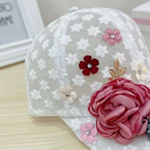 Detail of 3D fabric flowers and lace floral embroidery on breathable mesh sun hat