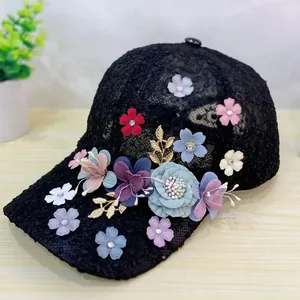 Detailed close-up of handmade floral lace baseball cap with pastel fabric flowers