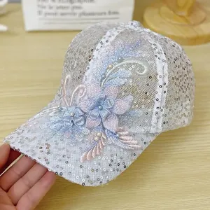 Detail of white lace baseball cap with sequins, 3D floral petals and pearl accents