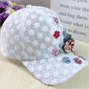 Detail of white mesh lace baseball cap with handmade 3D floral embroidery and rhinestones