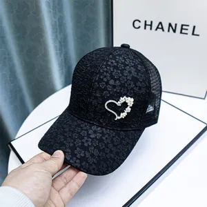 Detail of black rhinestone heart mesh baseball cap with 3D floral embroidery textures