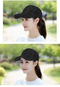 Close-up of women's black lace baseball cap with floral pattern and sparkling rhinestones