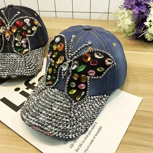 Gros plan détaillé sur des papillons en strass colorés sur des casquettes en jean bleu