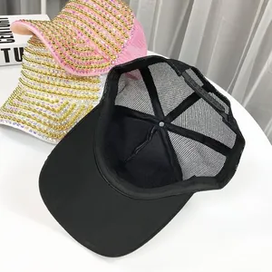 Close-up of baseball caps featuring heavy rhinestone pearls and breathable mesh design
