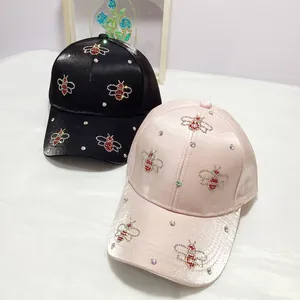 Women's satin baseball caps with rhinestone bee motifs in black and light pink colors