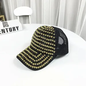 Close-up of luxury black mesh baseball cap featuring intricate gold beads and black rhinestones