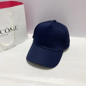 Close-up of navy blue twill cotton baseball cap with classic curved brim and smooth texture