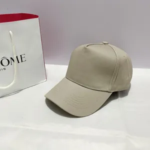 Classic beige five-panel baseball cap displayed on a white surface with a minimalist look