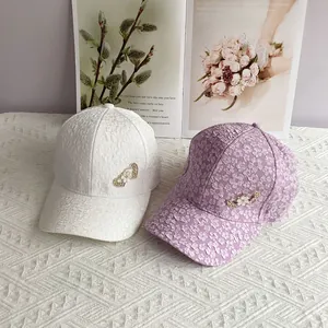 Detail of floral texture baseball caps with heart-shaped metal buckles and pearls