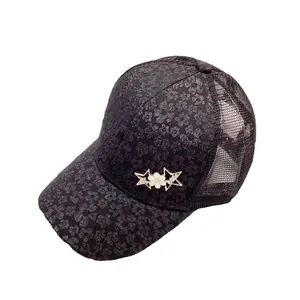 Women's black baseball cap with rhinestone star and floral texture on white background