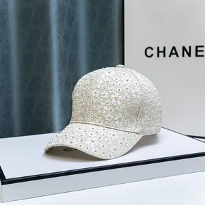 Fashionable baseball cap with white flower embroidery and rhinestones on beige base