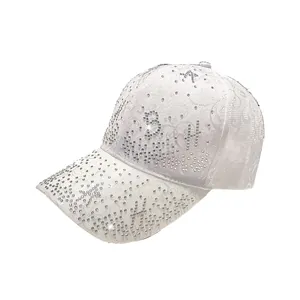 White baseball cap with floral lace pattern and sparkling rhinestone letter embellishments