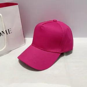 Detail of rose red twill cotton baseball cap with multi-row stitched brim and copper buckle